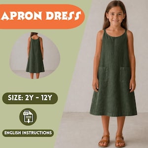 May include: An olive green apron dress with two front pockets and spaghetti straps. The image includes the text "APRON DRESS", "SIZE: 2Y - 12Y", and "ENGLISH INSTRUCTIONS". A young girl is wearing the dress.