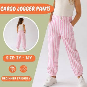 May include: Cargo jogger pants featuring a vertical pink and white striped pattern, a button closure at the waist, and two large front pockets. The pants have elasticized cuffs at the ankles and are paired with a plain white sleeveless top.