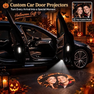 May include: Custom car door projectors that cast a personalised photo onto the ground. The black vehicle has open doors with illuminated interior lights. The projected image shows a smiling couple, one wearing a witch hat, on the pavement.