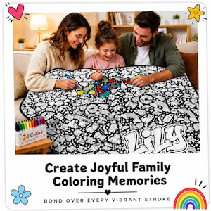 May include: A large white fabric colouring blanket featuring a black outline pattern of various icons including rainbows, stars, and cats, with the name Lily printed in large bubble letters. A box of 24 coloured markers sits on a small wooden table.