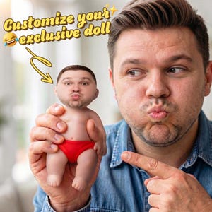 May include: A customized doll with a person's face, wearing red briefs, held by a man. The text "Customize your exclusive doll" is in yellow with a laughing emoji and a curved arrow pointing to the doll.