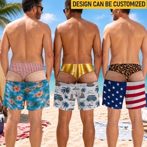 May include: Three pairs of swim trunks with distinct patterns. The left pair features red and white stripes with a blue floral print. The center pair has a gold band and a white base with blue palm trees and vans. The right pair shows leopard print and the American flag.
