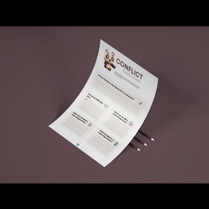 May include: A white sheet of paper with the words "Conflict Resolution" and a panda bear illustration. The paper has lines for writing and is accompanied by three black pencils on a brown background.