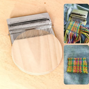 May include: A metal and wood weaving loom with a circular wooden base. The loom has metal teeth and a series of metal rods. The image also shows examples of woven fabric in various colors.