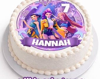May include: A round white cake with a decorative edible cake topper. The topper features three animated figures, a disco ball, musical notes, and the number 7. A purple banner displays the name "HANNAH". The words "edible cake topper" are at the bottom.