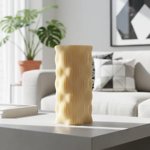 May include: A light yellow vase with a textured, wavy design. The cylindrical vase is made of a solid material and sits on a white table. The vase is a decorative item for home decor.
