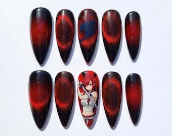 May include: A set of ten almond-shaped press-on nails featuring a dark black and red cat-eye magnetic polish effect. One nail displays a blue Fairy Tail guild emblem, while another nail features a detailed illustration of an anime character with long red hair holding a sword.