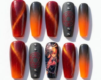 May include: A set of ten press-on nails featuring a mix of designs. Some nails have a glossy red and orange cat-eye magnetic finish, while others are matte black with silver studs and red circular symbols. One nail features an anime character.