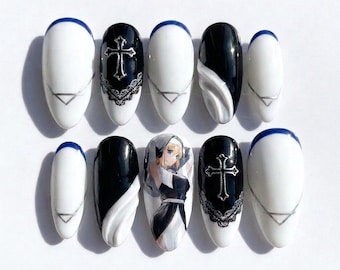 May include: A set of ten almond-shaped press-on nails featuring a black and white color palette. Designs include solid white nails with blue tips and silver geometric lines, black nails with silver cross emblems and lace details, and an anime nun illustration.