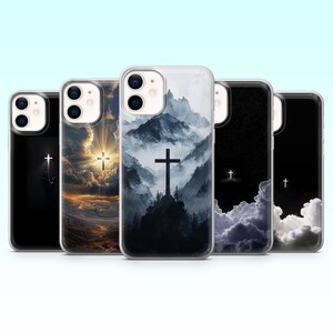 May include: A collection of phone cases featuring religious imagery. Each case displays a cross set against a backdrop of clouds, mountains, or a starry sky. The color palette includes shades of black, white, blue, and gold.