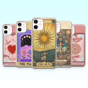 May include: A selection of phone cases with tarot card artwork. The cases showcase colourful illustrations, such as a heart and sword, a moonlit scene, a sun, a dancing figure, and a wheel of fortune. Each case has a transparent border.