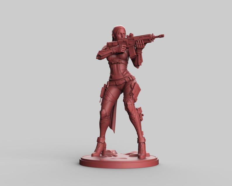 May include: A maroon-colored figurine of a female character in a combat pose, holding a rifle. The figure is wearing a detailed tactical outfit with pouches and knee pads. The figurine is standing on a circular base.