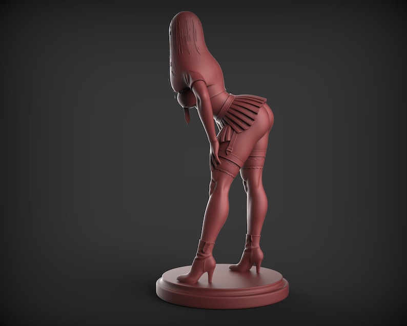May include: A maroon-colored figurine of a person in a suggestive pose, wearing a short pleated skirt, thigh-high stockings, and high-heeled boots. The figure is leaning forward, with the head and upper body angled downward. The figurine is on a circular base.