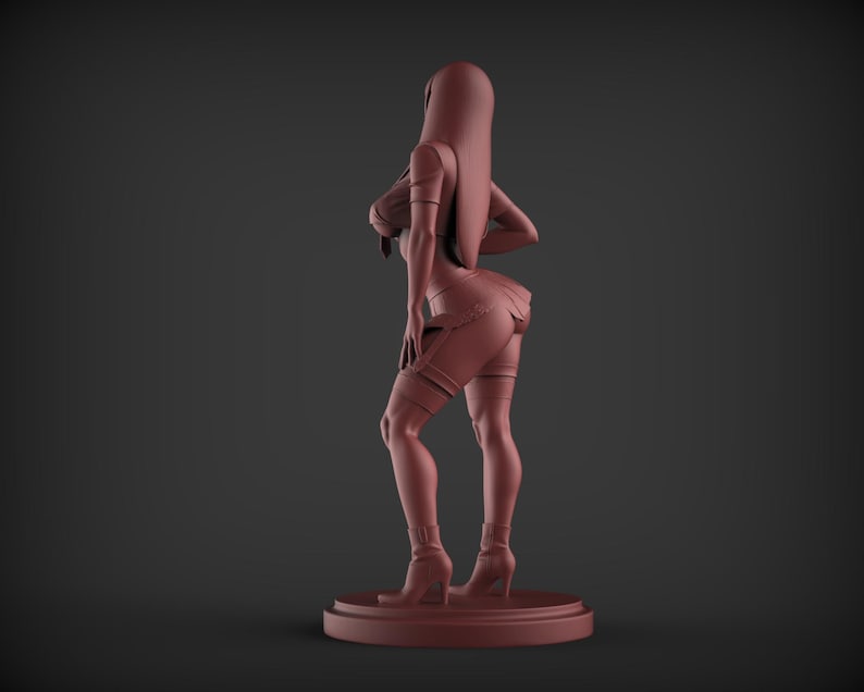 May include: A reddish-brown figurine of a person in a provocative pose. The figure is wearing a short dress, thigh-high garters, and high-heeled boots. The figurine is standing on a circular base against a dark background.
