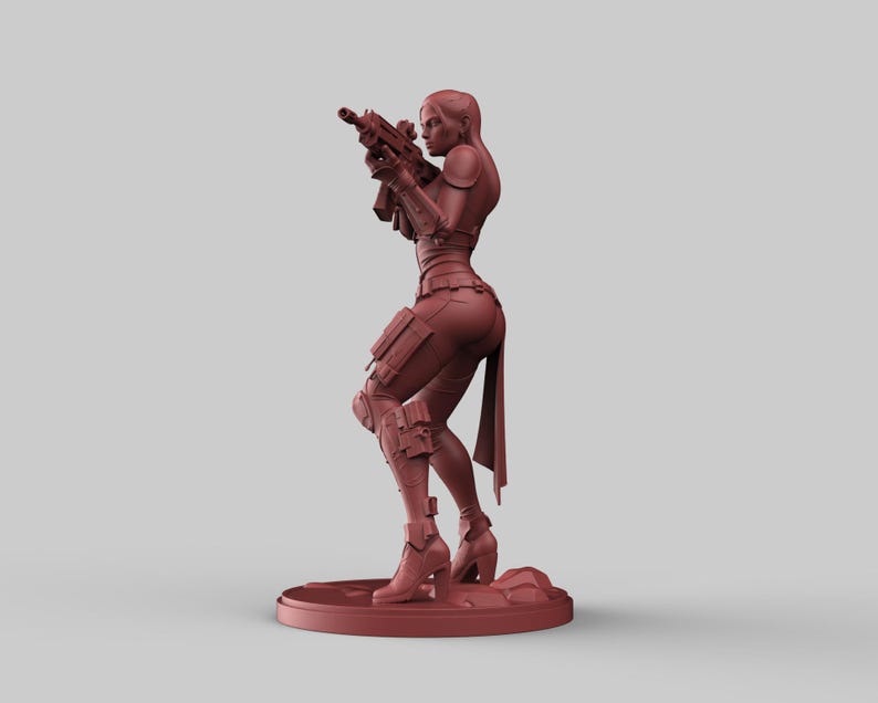 May include: A reddish-brown figurine of a person aiming a rifle. The figure is wearing tactical gear, including a vest, knee pads, and boots. The figurine is standing on a circular base.