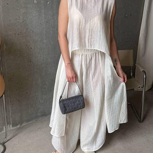 Women wearing ivory viscose tencel co-ord set with asymmetric tunic top and wide leg pants, minimalist summer outfit
