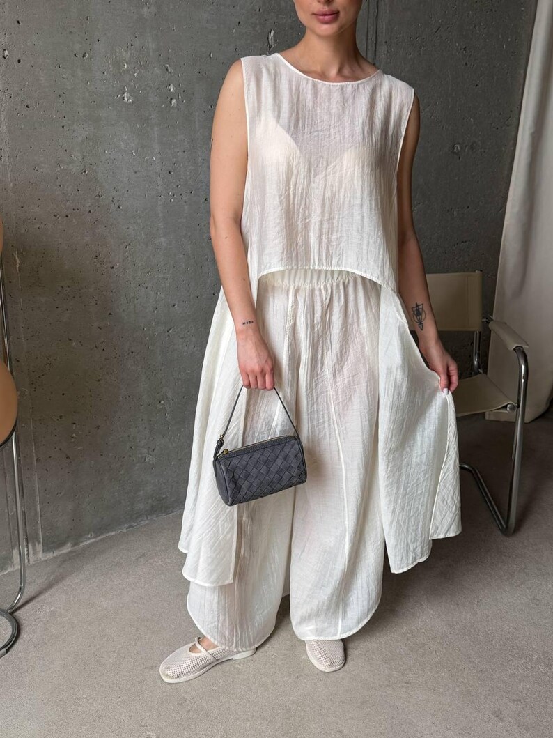 Women wearing ivory viscose tencel co-ord set with asymmetric tunic top and wide leg pants, minimalist summer outfit