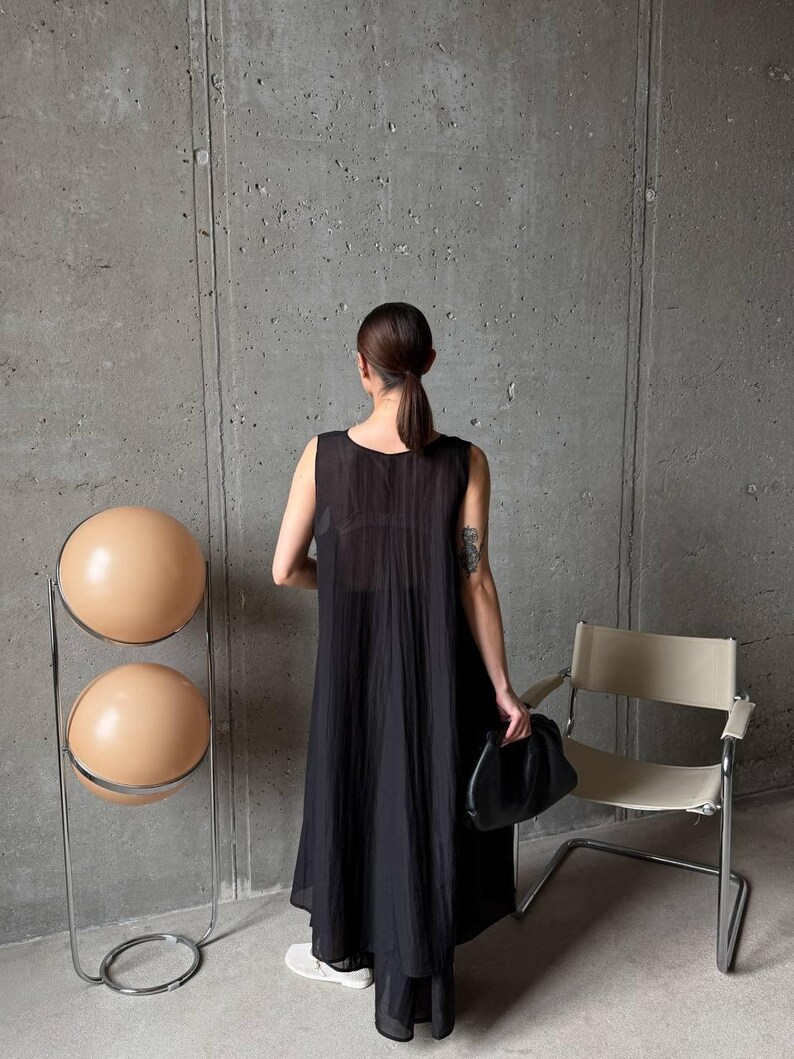 Back view of flowing asymmetric tunic and wide leg palazzo pants in ivory viscose tencel fabric, handmade ukrainian fashion