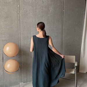 Back view of flowing asymmetric tunic and wide leg palazzo pants in ivory viscose tencel fabric, handmade ukrainian fashion