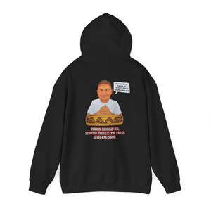 May include: Black hooded sweatshirt featuring a cartoon illustration of a person with a sandwich. The illustration includes the text "If you're not eating at [restaurant name], you're a bad dad."