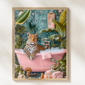 May include: A framed art print featuring a leopard relaxing in a pink bathtub filled with bubbles. The artwork is set in a lush, tropical bathroom with green foliage and a patterned wallpaper. A pink towel rests on the tub's edge.