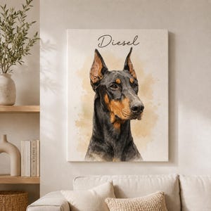 May include: A rectangular canvas wall art print featuring a watercolor-style portrait of a Doberman Pinscher dog with black and tan fur. The name Diesel is printed in a black cursive script above the dog's head against a light beige background.