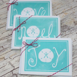 Turquesa Costa Arena Dollar Tarjetas de Navidad Joy Love Noel Tarjetas de vacaciones