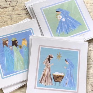 May include: Set of three Christmas cards featuring hand-painted illustrations of the Nativity scene. The first card shows Mary and Joseph with the baby Jesus in a manger. The second card shows the three wise men. The third card shows Mary holding the baby Jesus.