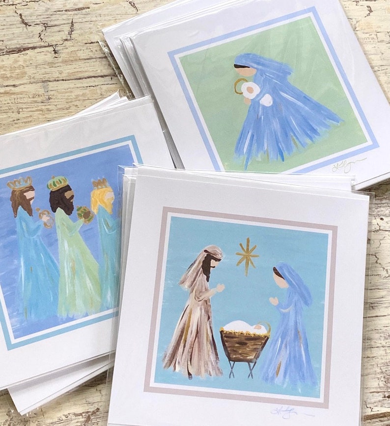 May include: Set of three Christmas cards featuring hand-painted illustrations of the Nativity scene. The first card shows Mary and Joseph with the baby Jesus in a manger. The second card shows the three wise men. The third card shows Mary holding the baby Jesus.