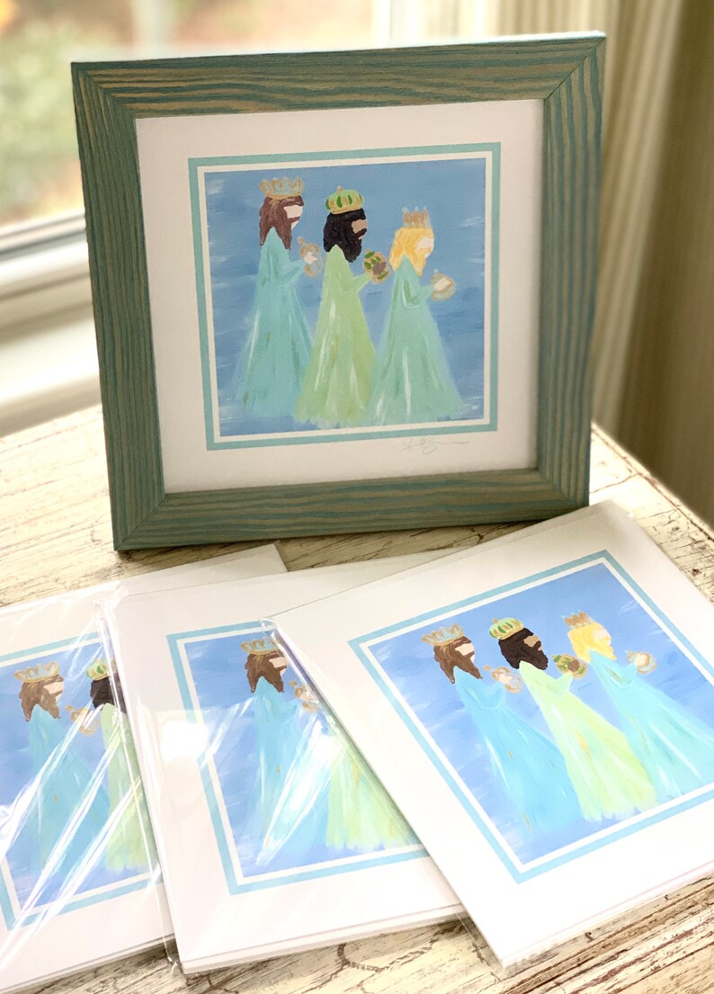 May include: Three figures in blue and green robes with gold crowns, holding gifts, on a blue background with a light blue border. The image is a print of a painting.