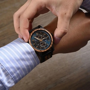 Handheld personalized wooden watch for men showing artisan wood texture, engraved men’s wristwatch gift idea