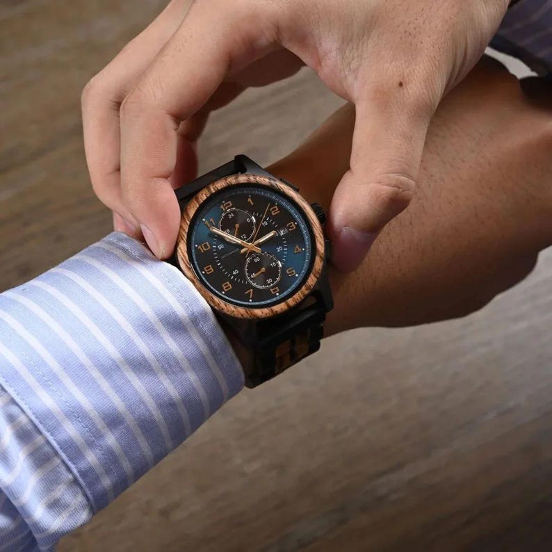 Handheld personalized wooden watch for men showing artisan wood texture, engraved men’s wristwatch gift idea