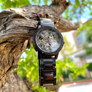 Angled view of mens wood watch Showing custom personalization message and red second hand