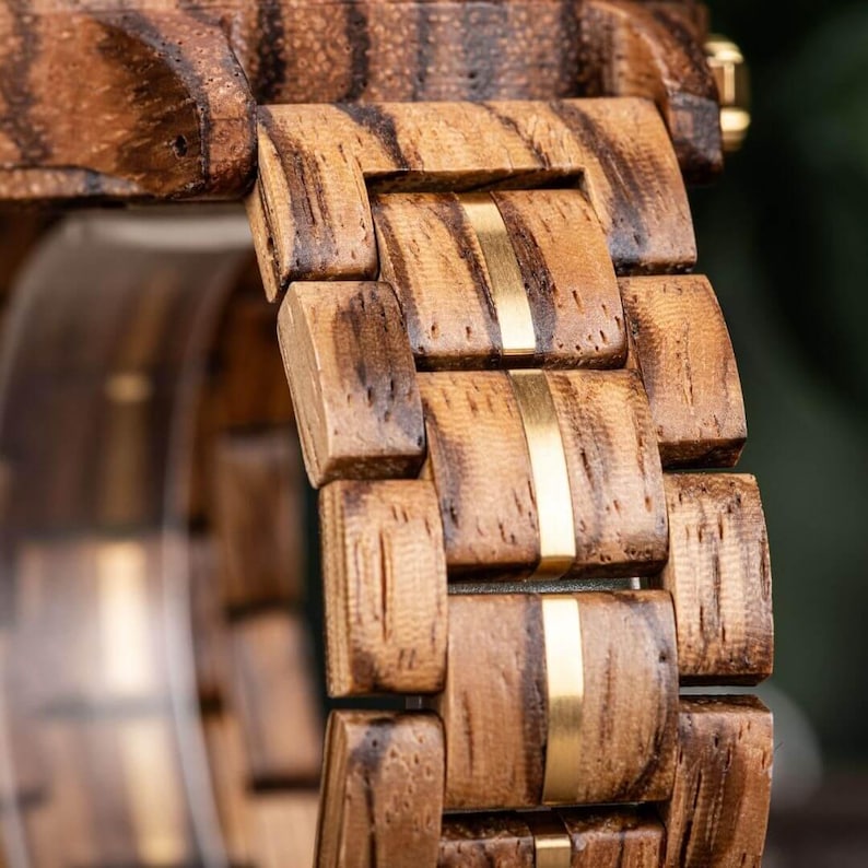 Close up of wooden and stainless steel strap on handmade zebrawood men’s wrist watch