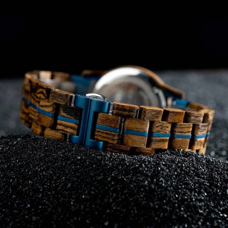 Mens engraved watch clasp detail with secure stainless steel folding buckle mechanism

Wooden watch buckle close up showing adjustable band length and polished metal clasp