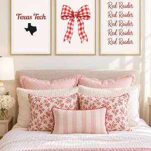 May include: Three framed wall art prints with gold frames. The left print features the text Texas Tech and a black silhouette of the state of Texas. The center print shows a red and white gingham bow. The right print displays the text Red Raider.