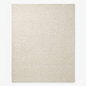 May include: A rectangular, off-white rug with a textured surface. The rug has a simple, neutral design, suitable for various interior styles. The rug's color is a light cream, providing a soft and inviting look.