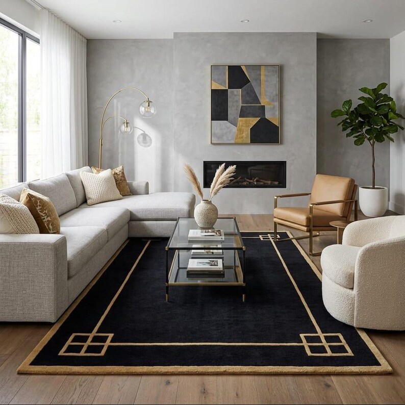 May include: A contemporary living room with a light grey corner sofa, a black rug with a gold geometric border, and a glass coffee table. A gold arc lamp and abstract art piece enhance the decor. A leather armchair and a white swivel chair complete the space.
