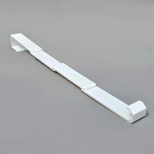 May include: A white, adjustable, rectangular shelf support. The support is made of a solid material and features a right-angle bracket on each end. The support is designed to extend and retract, with two sections connected by hinges.