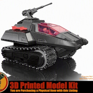 May include: A dark grey 3D printed model tank featuring black tank treads, a rotating turret with a mounted cannon, and a translucent red cockpit canopy. A small red missile is attached to the side of the vehicle body, which has angular, geometric armour plating.
