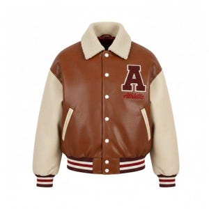 May include: Brown and cream-colored varsity jacket with a white shearling collar. The jacket features a large letter "A" patch with "Athletic" in red script. The sleeves are cream-colored, and the jacket has a striped hem and cuffs.