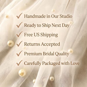 May include: A sheer white tulle fabric adorned with scattered cream-coloured pearls. Overlaid text includes: Handmade in Our Studio, Ready to Ship Next Day, Free US Shipping, Returns Accepted, Premium Bridal Quality, and Carefully Packaged with Love.