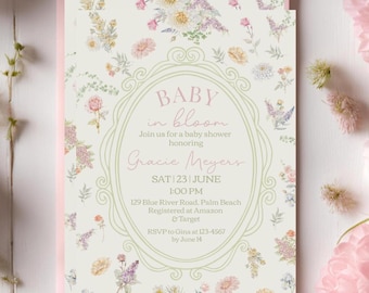 May include: A baby shower invitation with a floral design. The invitation features the text "BABY in bloom" and details for Gracie Meyers' baby shower. The invitation is surrounded by pink and white flowers.