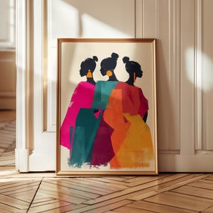 May include: Framed art print featuring three silhouetted figures with up-swept hair and large earrings. The figures are depicted in vibrant colors: pink, teal, burgundy, orange, and yellow. The artwork is set against a neutral background and framed in gold.