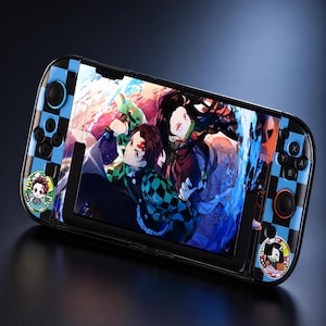 May include: A handheld gaming console featuring a blue and black checkered skin. The screen displays an anime illustration of two characters with dark hair. Two circular stickers featuring chibi-style anime characters are applied to the controller sides.