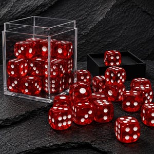 May include: A collection of translucent red six-sided dice with white pips. Many dice are contained within a clear square acrylic box, while others are scattered outside. One die rests inside a small black square tray, and several others sit nearby.