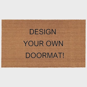 May include: A rectangular brown doormat with the text "DESIGN YOUR OWN DOORMAT!" in black. The mat is made of a natural fiber material, likely coir, and is suitable for outdoor use.