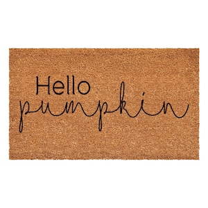 May include: A rectangular brown coir doormat with a textured, fibrous surface. The text "Hello" is printed in a bold, black sans-serif font on the top left, followed by the word "pumpkin" in a black, flowing cursive script underneath.