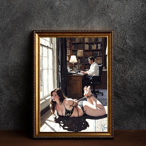 May include: A framed artwork shows a woman in black lingerie tied up on the floor, gazing out a window. A man works at a desk in the background. The frame is gold, and the artwork is set against a dark grey textured wall.