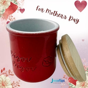 May include: A white ceramic mug with a black handle and the text "But First, Coffee" in a handwritten style. The mug is on a white surface. The mug is approximately 4 inches tall.